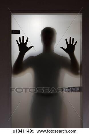 Stock Photography - Silhouette of a man on a door. Fotosearch