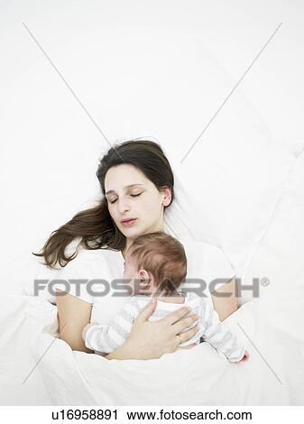 Stock Image - sleeping mother and baby. Fotosearch