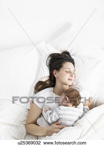 Stock Image - sleeping mother and baby. Fotosearch