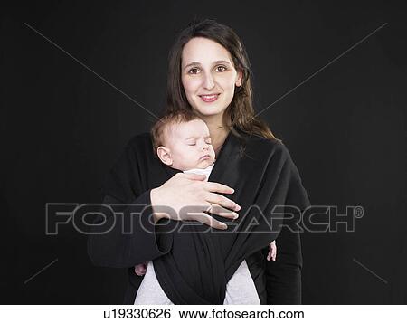 Stock Photograph - smiling mother with sleeping baby. Fotosearch