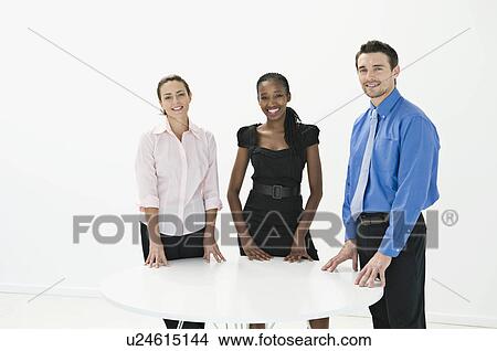 Three business colleagues smiling. View Large Photo Image Picture - Three business colleagues smiling.. Fotosearch