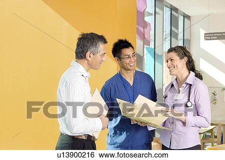 Three medical colleagues talking View Large Photo Image Stock Photograph - Three medical colleagues talking. Fotosearch