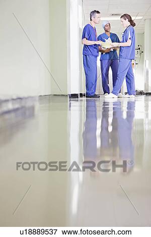 Stock Photo - Three medical staff talking. Fotosearch