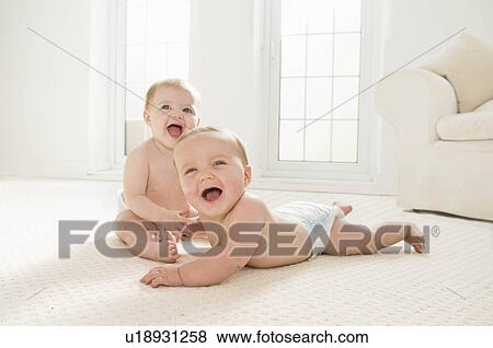 Two babies laughing together. View Large Photo Image Stock Photo - Two babies laughing together.. Fotosearch