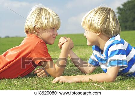Stock Image - two boys arm wrestling. Fotosearch