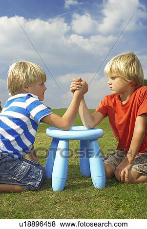 Stock Photo - two boys arm wrestling. Fotosearch