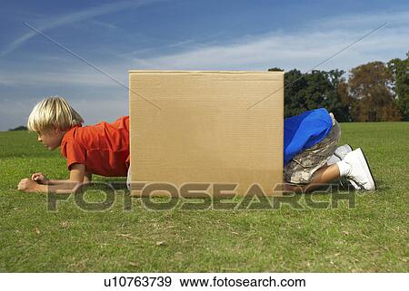 two boys crawling into box View Large Photo Image Stock Photo - two boys crawling into box. Fotosearch