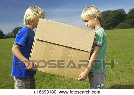 Stock Image - two boys holding box. Fotosearch