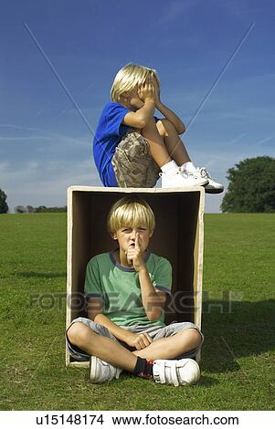 Picture - two boys playing with box. Fotosearch