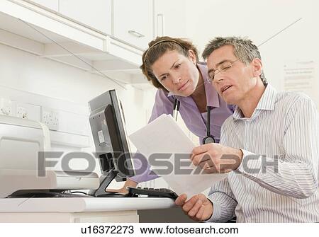 Two doctors discuss some notes View Large Photo Image Stock Image - Two doctors discuss some notes. Fotosearch