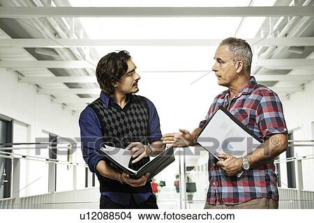 Two men having a business conversation View Large Photo Image Picture - Two men having a business conversation. Fotosearch