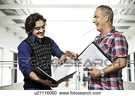 Stock Image - Two men having a business conversation. Fotosearch