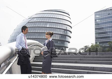 Two office workers outside talking View Large Photo Image Stock Image - Two office workers outside talking. Fotosearch