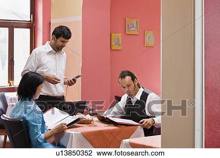 Waiter taking orders from customers View Large Photo Image Stock Image - Waiter taking orders from customers. Fotosearch