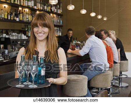 Waitress holding tray of drinks View Large Photo Image Stock Photograph - Waitress holding tray of drinks. Fotosearch