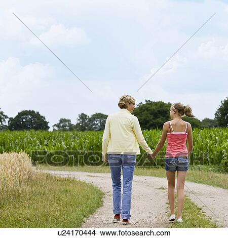 Picture - Woman and girl taking a walk. Fotosearch