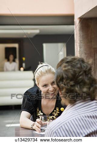Woman and man talking over drinks View Large Photo Image Picture - Woman and man talking over drinks. Fotosearch