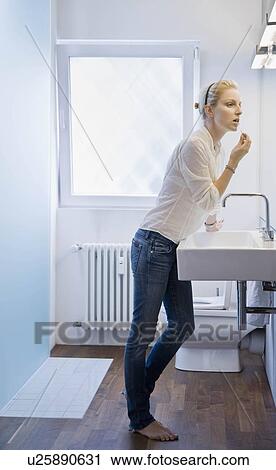 Woman applying makeup View Large Photo Image Stock Image - Woman applying makeup. Fotosearch