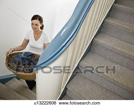 Stock Photograph - Woman carrying the laundry. Fotosearch