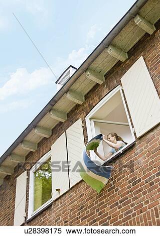 Woman cleaning a rug out a window View Large Photo Image Stock Photography - Woman cleaning a rug out a window. Fotosearch