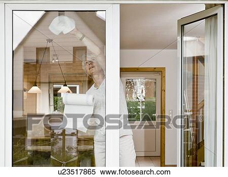 Stock Photography - Woman cleaning a window. Fotosearch