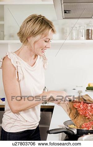 Woman cooking View Large Photo Image Stock Photograph - Woman cooking. Fotosearch