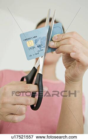 Woman cutting up her credit card View Large Photo Image Stock Photo - Woman cutting up her credit card. Fotosearch