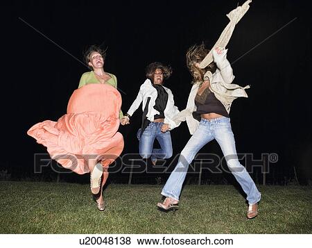 Stock Photo - Woman dancing in the dark. Fotosearch