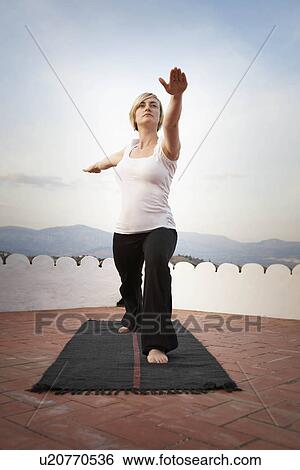 Stock Photograph - Woman doing yoga. Fotosearch