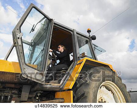 Stock Photography - woman driving tractor. Fotosearch