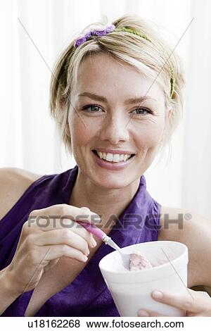 Woman eating ice cream View Large Photo Image Stock Photo - Woman eating ice cream. Fotosearch