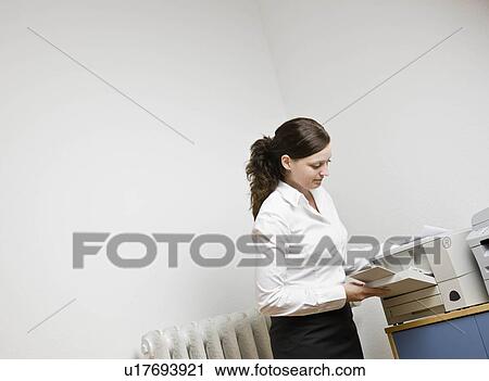 Woman filling a printer with paper View Large Photo Image Stock Image - Woman filling a printer with paper. Fotosearch