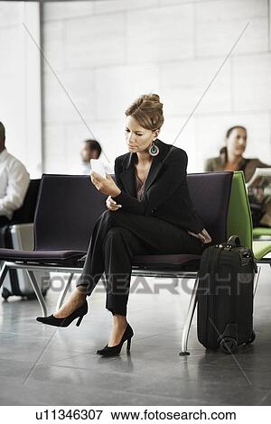 Woman holding cellphone, waiting View Large Photo Image Stock Photo - Woman holding cellphone, waiting. Fotosearch