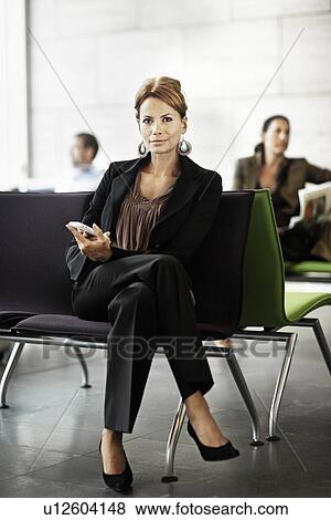 Woman holding cellphone, waiting View Large Photo Image Stock Photo - Woman holding cellphone, waiting. Fotosearch
