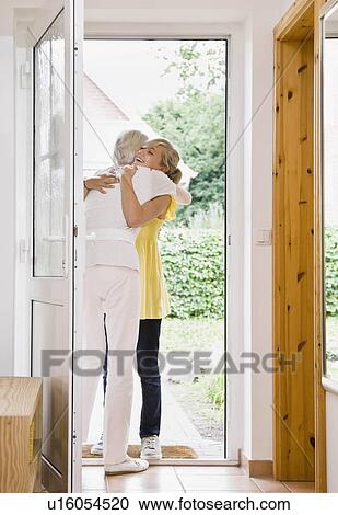 Woman hugging a young girl View Large Photo Image Stock Image - Woman hugging a young girl. Fotosearch