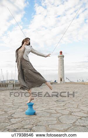 woman jumping in front of lighthouse View Large Photo Image Stock Photograph - woman jumping in front of lighthouse. Fotosearch