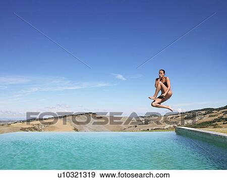 Woman jumping in swimming pool View Large Photo Image Stock Photo - Woman jumping in swimming pool. Fotosearch