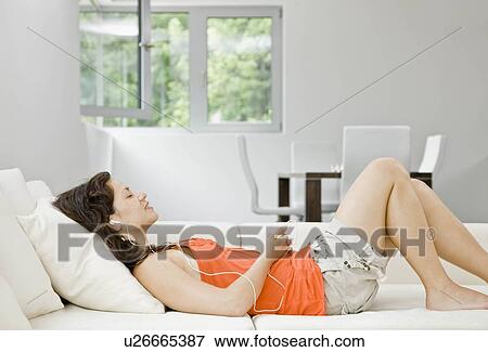 Woman listening to her mp3 player View Large Photo Image Stock Photo - Woman listening to her mp3 player. Fotosearch