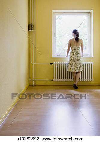 Woman looking out a window View Large Photo Image Stock Image - Woman looking out a window. Fotosearch