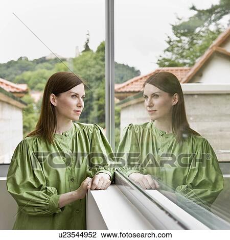 Woman looking out the window View Large Photo Image Stock Image - Woman looking out the window. Fotosearch