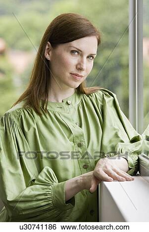 Stock Photograph - Woman looking out the window. Fotosearch