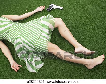 Woman lying on floor with gun View Large Photo Image Stock Image - Woman lying on floor with gun. Fotosearch