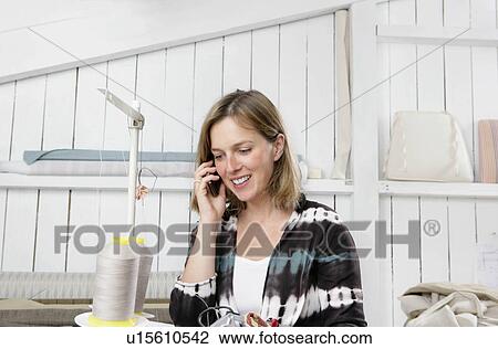 woman on mobile in workshop View Large Photo Image Stock Image - woman on mobile in workshop. Fotosearch