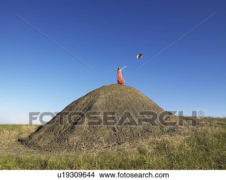 Woman on top of hill throwing hat View Large Photo Image Picture - Woman on top of hill throwing hat. Fotosearch