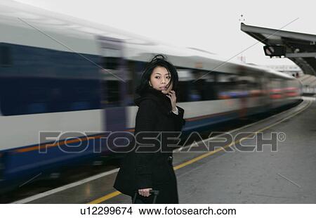 Picture - Woman on train platform. Fotosearch