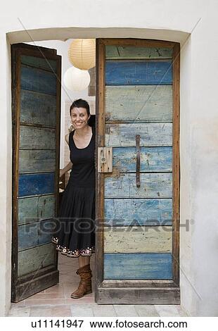 Woman peeking out door View Large Photo Image Stock Photo - Woman peeking out door. Fotosearch