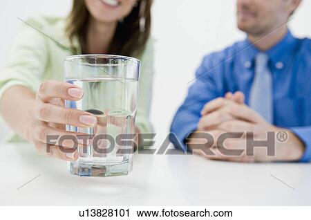 Woman reaching for a water glass View Large Photo Image Stock Image - Woman reaching for a water glass. Fotosearch