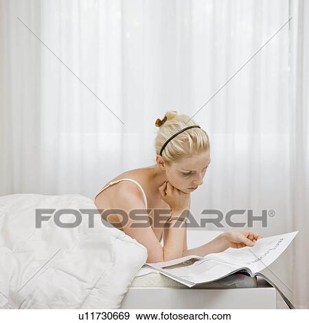 Woman reading a magazine View Large Photo Image Stock Photo - Woman reading a magazine. Fotosearch