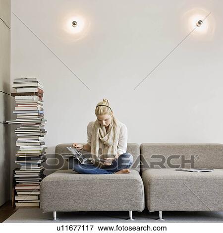 Woman reading a stack of books View Large Photo Image Stock Photo - Woman reading a stack of books. Fotosearch