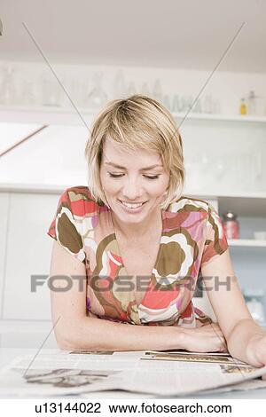 Woman reading newspapers View Large Photo Image Stock Image - Woman reading newspapers. Fotosearch